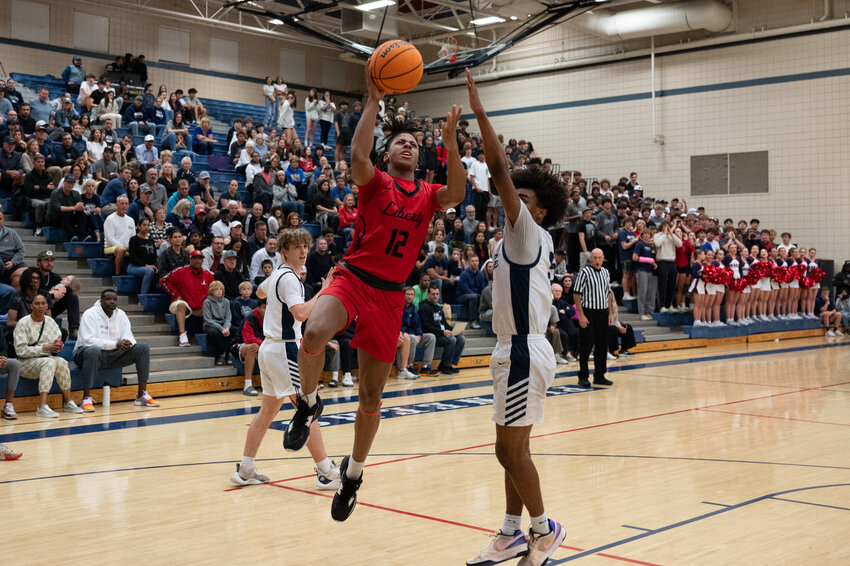 Liberty junior guard Stephen Miller puts up a layup in a second half of the Lions' 79-77 win in a 6A basketball playoff semifinal at Pinnacle High School in Phoenix Feb. 28.