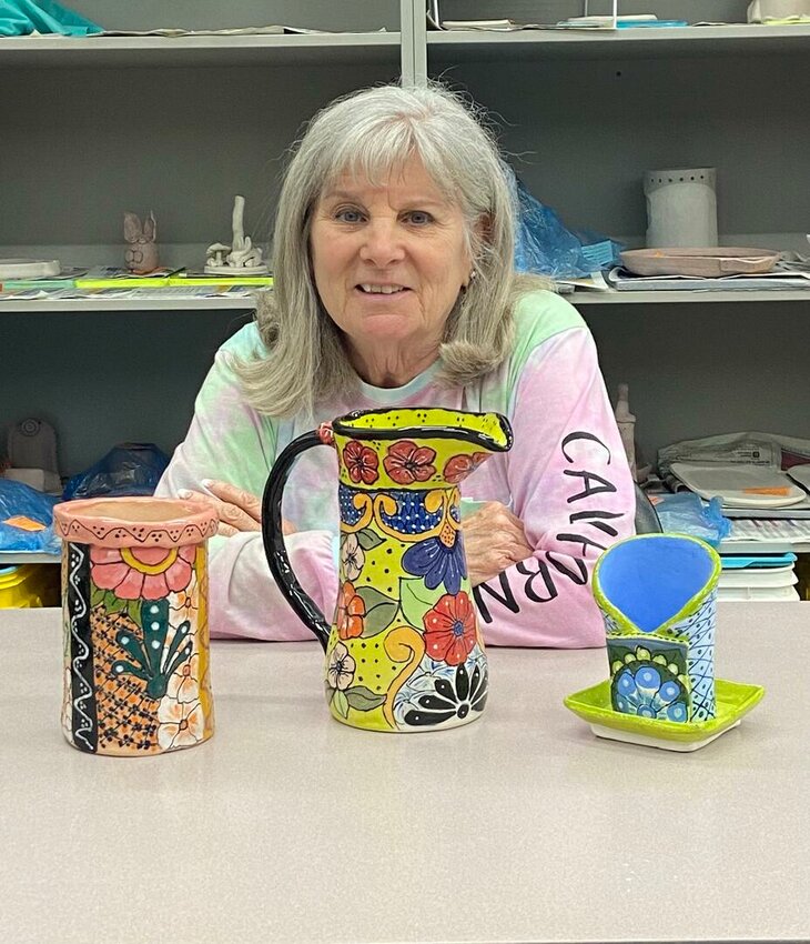 Clay Club member Sue Dellner and examples of Talavera pottery.