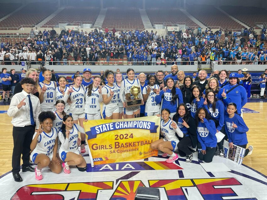 The Canyon View girls basketball team, coaches, family and friends celebrate winning the 5A state championship March 1 at Veterans Memorial Coliseum in Phoenix.