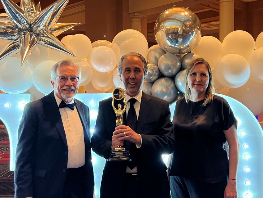 David Kitnick, Rosewood Homes president and founder, holding the Gold Award flanked by Art Sturz, Alliance 4 Design, and Jamie Haney, Rosewood Homes.