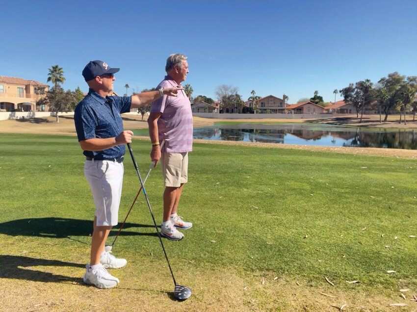 Two Arrowhead Ranch residents and golfers look at the pond on hole six of Arrowhead Country Club in Glendale. Foul odors emanating from the pond have become worse in recent years, and course owner Arcis is under pressure to implement a solution soon