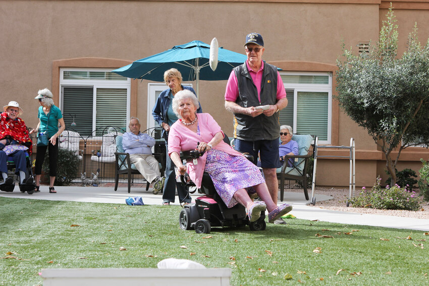 Therese Cuban throws a cornbag from her wheelchair during the Saturday corhole competition at MorningStar Senior Living in Fountain Hills.