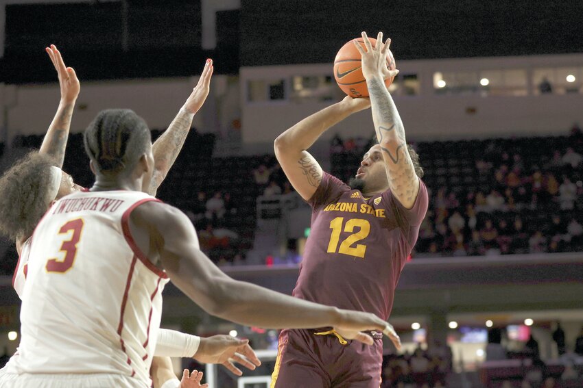 Arizona State guard Jose Perez (12) shoots the ball defended by Southern California forward DJ Rodman, left, and forward Vincent Iwuchukwu (3) during the second half of game Thursday, March 7 in Los Angeles. Southern California won 81-73. (The Associated Press/Raul Romero Jr.)