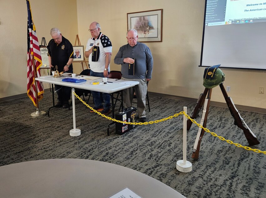 The customary three rifles and helmet formation, with a Post 94 cover to represent the passing of comrades during the past year. Post 94 Chaplain Paul Van Rooy tolls the bell, as Finance Officer Bob Hasbrouck and Adjutant Jim Heller look on, with Post Commander (not pictured) reading the names.