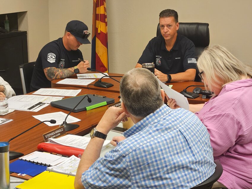 Rob Schmitz, Sun City Fire District acting chief, consults on changes to update the fire chief&rsquo;s job description with its board of directors during a work session March 12.