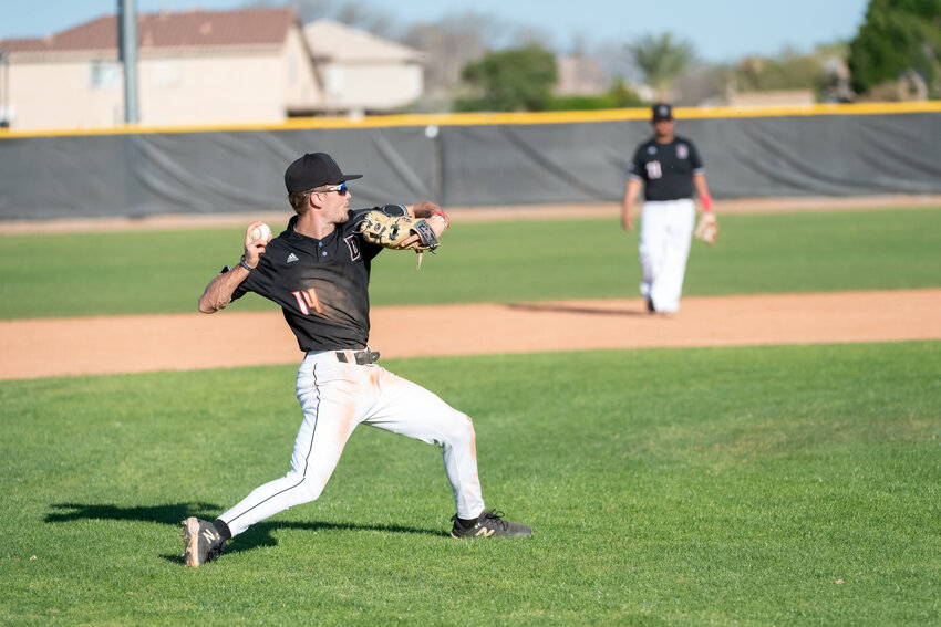 Dysart senior Ian Anderson throws to first base during the Demons&rsquo; March 1 home win against Moon Valley.