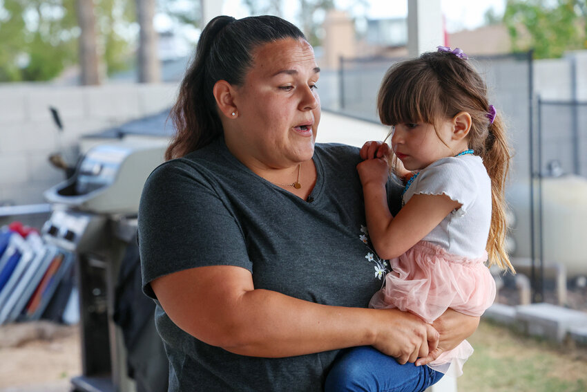 Brandi Stoll holds her 4-year-old daughter, Alizah Aguilar, on Feb. 21, 2024, at their home in Phoenix while discussing the family&rsquo;s decision to install a fence around their pool. Alizah nearly drowned in the pool more than two years ago.