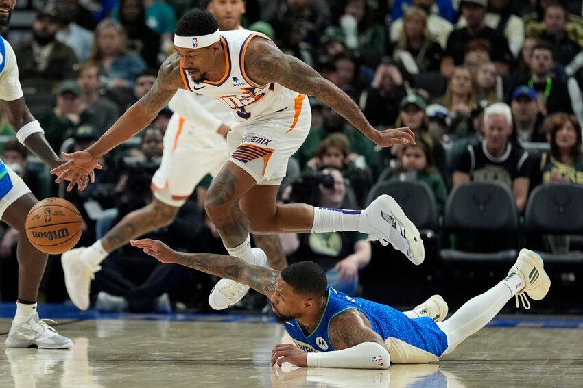Phoenix Suns&rsquo; Bradley Beal and Milwaukee Bucks&rsquo; Damian Lillard go after a loose ball during the second half of an NBA basketball game Sunday, March 17. The Bucks won 140-129.