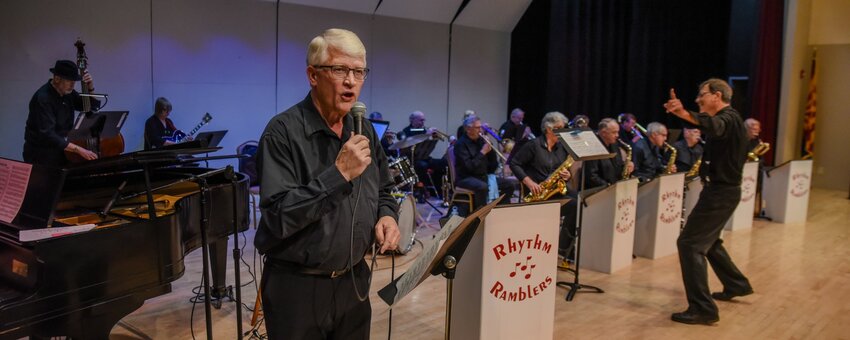 Rhythm Ramblers trombonist Jim Lee sings as music director Bryan Altherr leads the band.