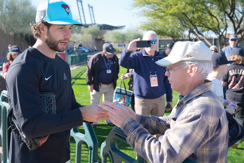 Diamondbacks starting pitcher Zac Gallen signs autographs during spring training workouts Wednesday, Feb. 14 at Salt River Fields in Scottsdale. (The Associated Press/Ross D. Franklin)