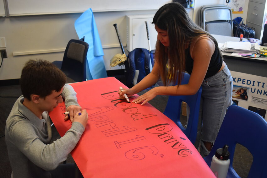 Key Club members senior William Breen and senior Elizabeth Franzone work on Blood Drive promotional posters. (Independent Newsmedia/George Zeliff)