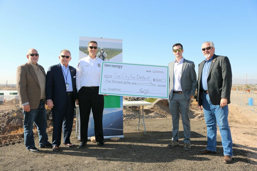 Invenergy developer Paul Burman, fourth from left, presented Sun City Acting Fire Chief Rob Schmitz, third from left, with a donation to support the department&rsquo;s fire, medical and emergency services Dec. 14, 2023. Also pictured are Arizona State Rep. David Livingston, Youngtown Mayor Michael LeVault and Arizona State Sen. Frank Carroll.