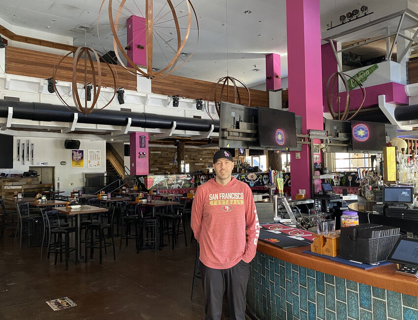 Salt Tacos y Tequila Marketing Director Scott McIntire stands next to the bar at the restaurant March 20, which is across a Westgate plaza from Desert Diamond Arena. The University of Kansas graduate is preparing this destination near State Farm Stadium for Final Four-related crowds.