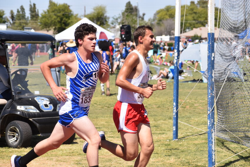 Sophomore Chase Anglemyer passes another runner on the final lap of the 1600m. (Independent Newsmedia/George Zeliff)