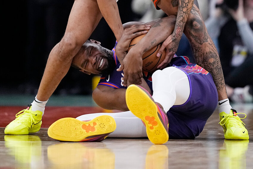 Phoenix Suns forward Kevin Durant, bottom, fights for a loose ball with San Antonio Spurs forward Jeremy Sochan during the second half of an NBA basketball game in San Antonio, Monday, March 25.