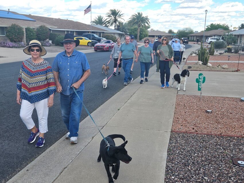 Dog walks have become a daily social event for Sun City residents on W. Timberline Drive.
