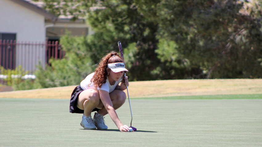 Peyton Gibby of Gilbert lines up her ball on a green at the Seville Golf and Country Club during the Ford Championship's Pro-Am event March 27.