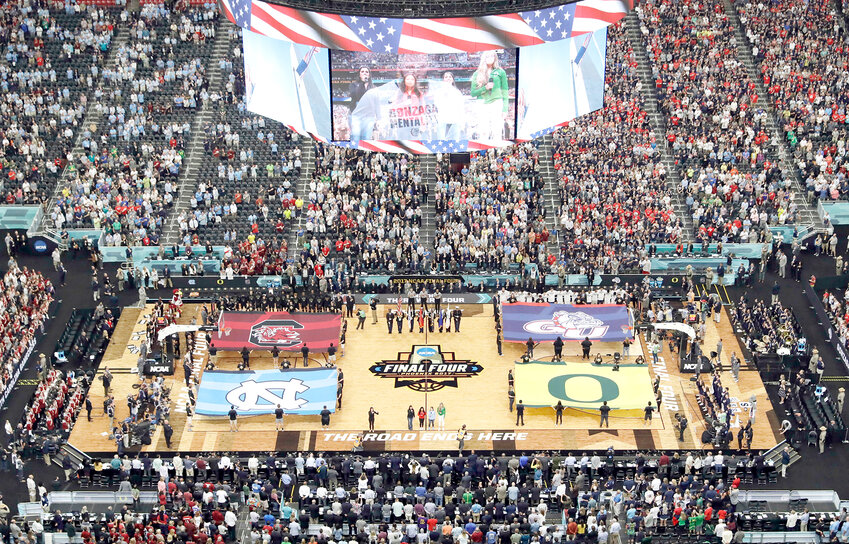 FILE - In this April 1, 2017, file photo, fans stand as they observe the national anthem before the  Final Four in the NCAA college basketball tournament in Glendale, Ariz. NCAA President Mark Emmert says NCAA Division I basketball tournament games will be played without fans in the arenas because of concerns about the spread of coronavirus. (AP Photo/Morry Gash, File)