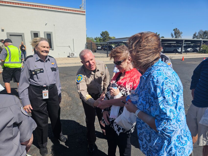 Sun City Posse Cmdr. Sarah Davis and Sheriff Russ Skinner talk with guests at the Posse&rsquo;s open house March 30.