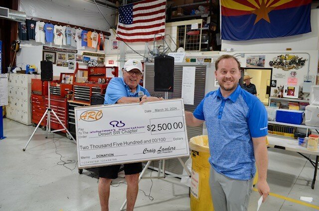 Tournament Director Chuck Willkom presents a check to Matt McNally, of Edward Jones, for Alzheimer&rsquo;s Association, Desert SW Chapter.