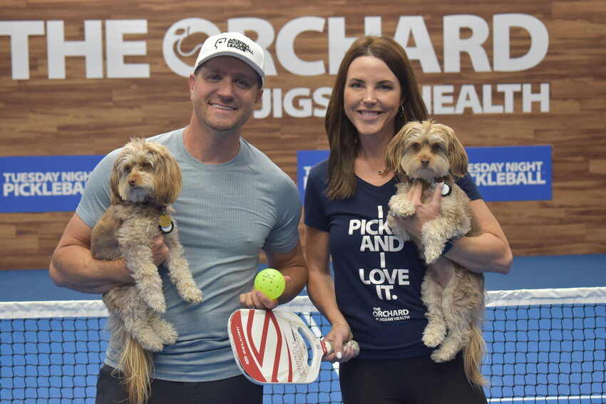 Patrick Sullivan, Jr., and Ashley Leroux pose with their Pickleball Pups at The Orchard at Jigsaw Health. (Independent Newsmedia/George Zeliff)