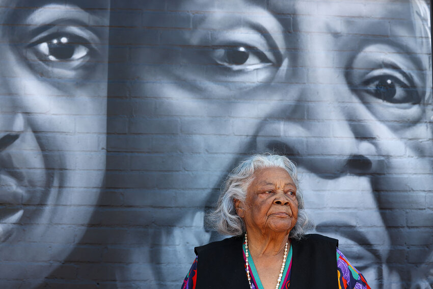 Elizabeth White, 101, stands in front of the Legacy Project mural painted at Eastlake Park Community Center in Phoenix after the unveiling of the NCAA Men&rsquo;s Final Four Legacy Project, which refurbished indoor and outdoor basketball courts and upgraded other amenities at the center. (Photo by Kayla Mae Jackson/Cronkite News)