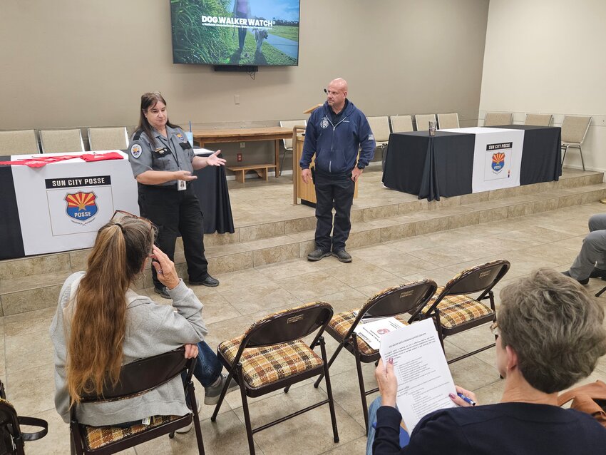 Sun City Posse Master Sgt. Bev Hooson and Sun City Fire Marshal Kenny Kovac inform residents of what to look for while walking their dogs to help be the &ldquo;eyes and ears&rdquo; of the community.