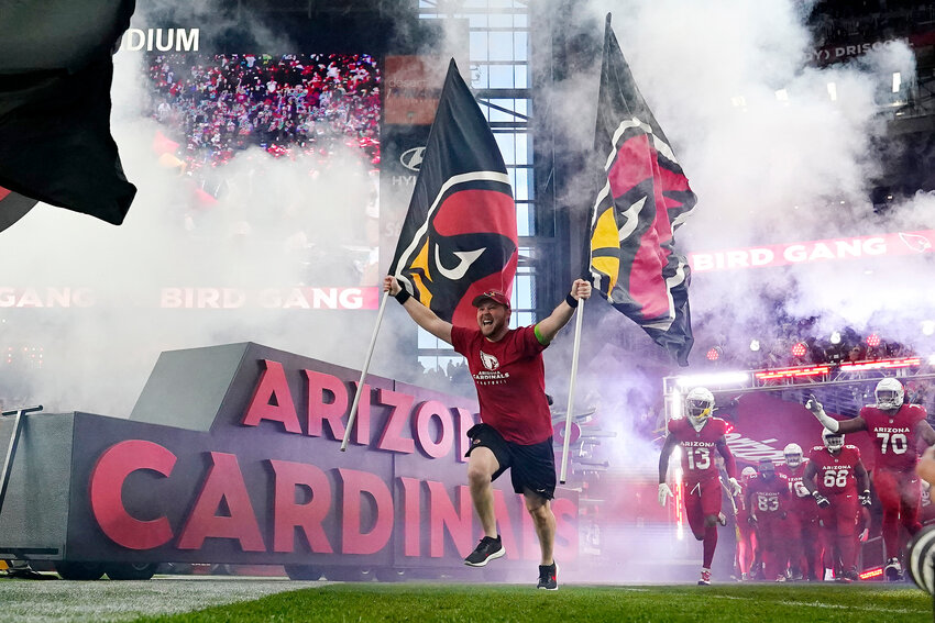 The Cardinals run on the field prior to a game Jan. 7, 2024, in Glendale.