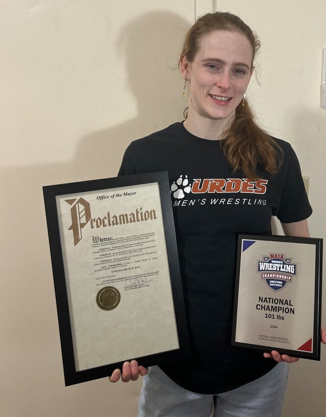 Stefana Jelacic shows off her proclamation for Stefana Jelacic Day and her national title plaques. (Submitted photo/Stefana Jelacic)