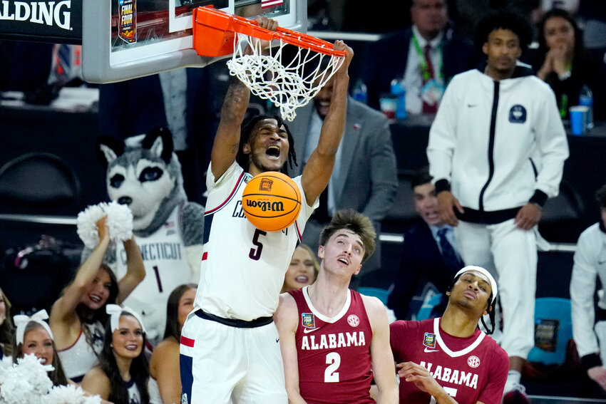 UConn guard Stephon Castle (5) dunks over Alabama forward Grant Nelson (2) during the second half of the NCAA college basketball game at the Final Four, Saturday, April 6, 2024, in Glendale.