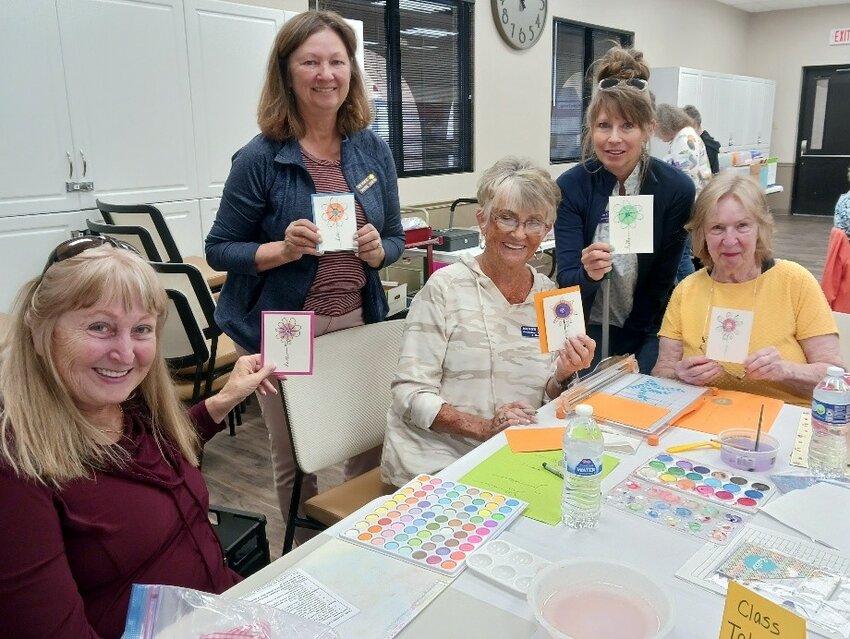 Members displaying the watercolor flower cards made during SPAM&rsquo;s spring crop are Linda Cherry, Sherre Chapin (instructor), Hanny Cole, Lanie Compton and Bev Giller.
