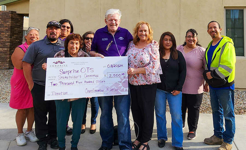 City Councilmember Ken Remley, center, delivers the ceremonial check to the Surprise Original Townsite Stakeholders Committee to help organize a revived Founders Day celebration on April 13.