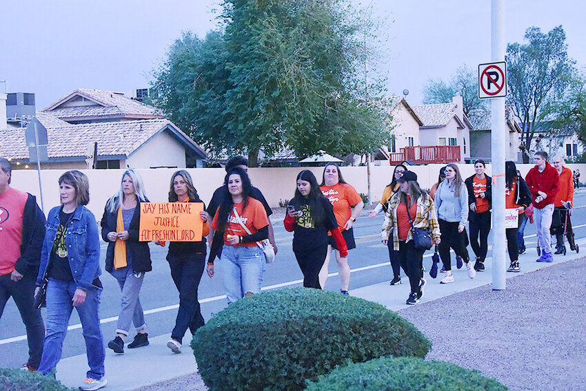A group walks to a Chandler Unified School District Governing Board meeting in February in memory of East Valley teen Preston Lord and other victims of teen violence. Several parents and other East Valley residents have demanded more action from local governments.