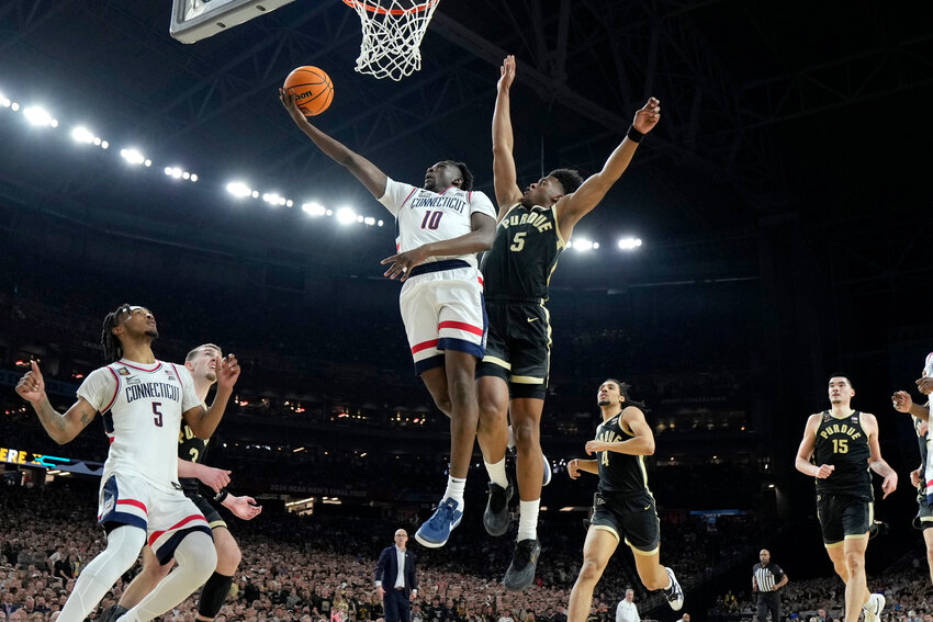 UConn guard Hassan Diarra (10) shoots past Purdue guard Myles Colvin during the second half of the NCAA men's college basketball championship game, Monday, April 8, 2024, in Glendale.