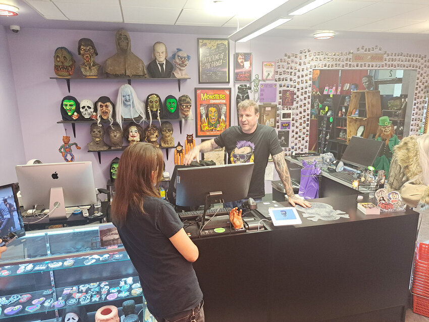 Terror Trader co-owner Jason Swarr talks with a customer at the North Chandler store. Specializing in all types of terror, horror and dark movie memorabilia, the store has expanded twice since it opened fewer than three years ago.
