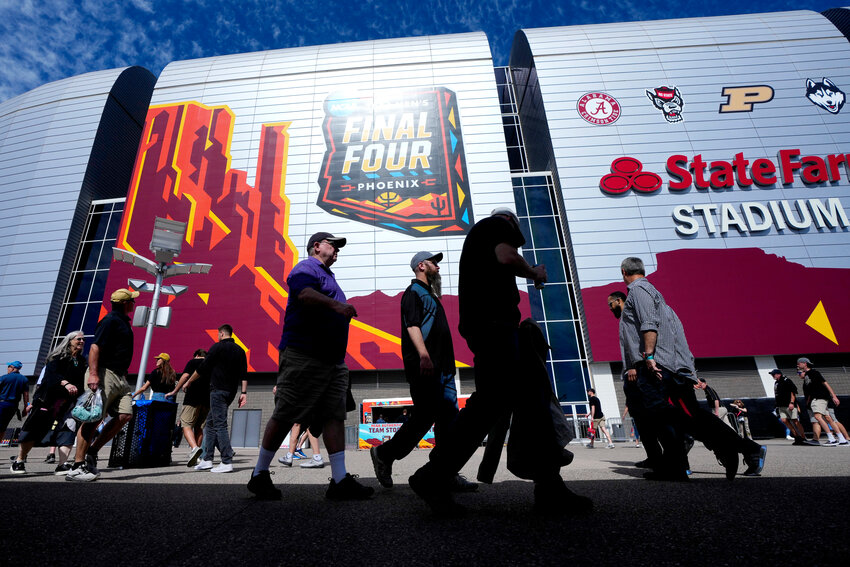 Fans arrive at State Farm Stadium prior to the NCAA college Final Four championship basketball game between Purdue and UConn, Monday, April 8, 2024, in Glendale, Ariz. (AP Photo/Ross D. Franklin)