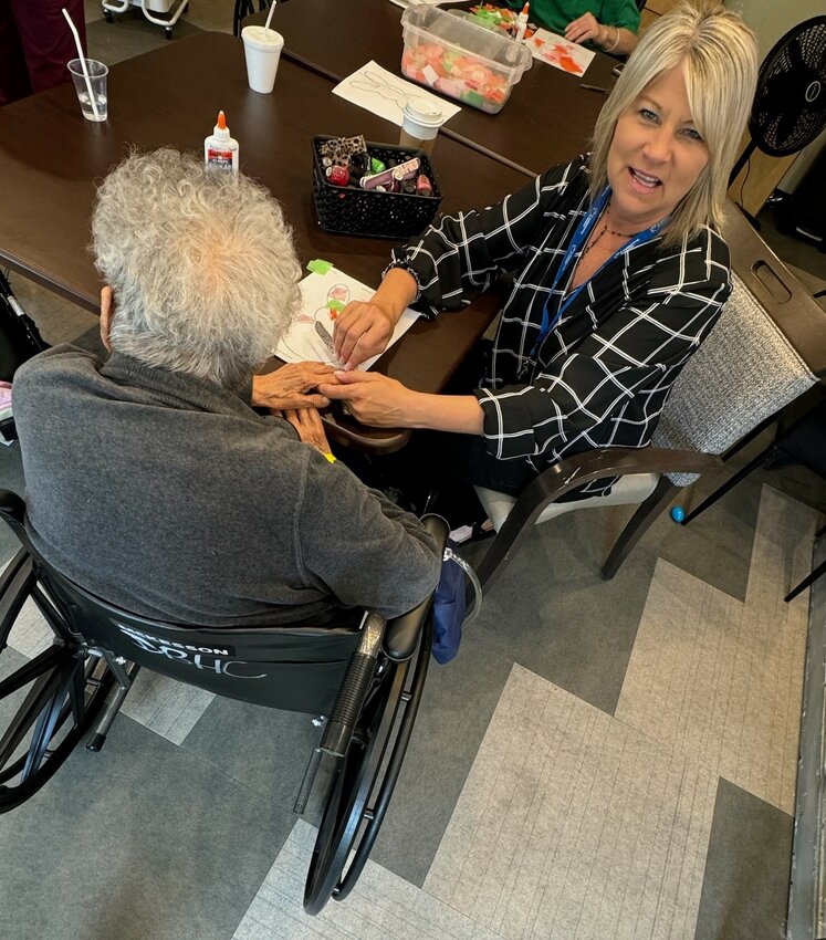 Glendale resident Tera Johnson paints the nails of a senior resident at Diamondback Health and Memory Care in West Phoenix. Johnson is a senior living advisor from Assisted Living Locators Phoenix.