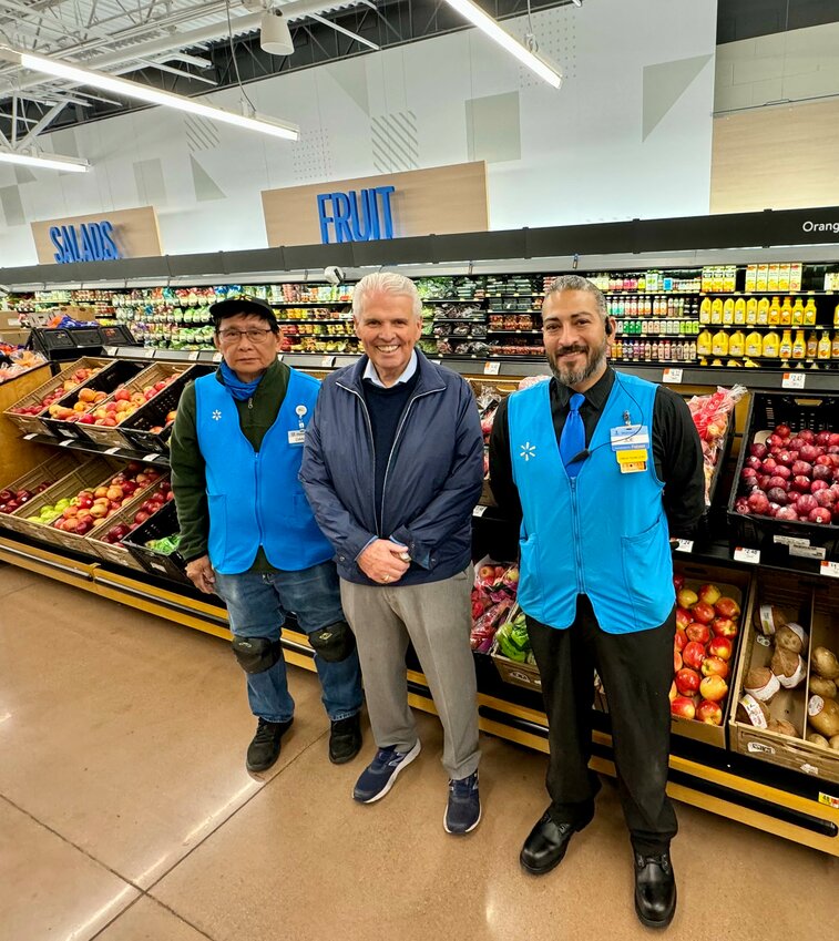 Surprise Mayor Skip Hall, center, smiles with a couple of Walmart Surprise Market workers during the grand re-opening of the store on April 5.