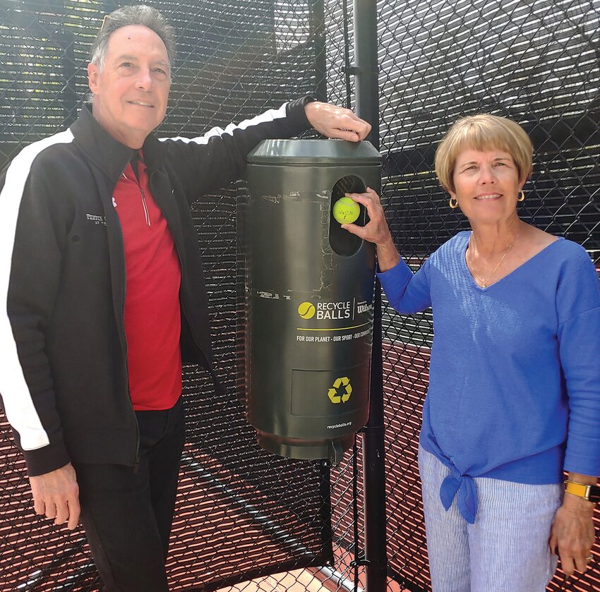 Lowell Keppel and Linda Heining show how easy it is to dispose of tennis balls that need to be retired in the recycling bin at the courts at the Trilogy Tennis Club in Peoria.