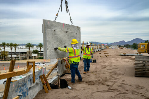 A crew builds a wall earlier this month as part of the construction of the ramps connecting I-10 and SR 143.
