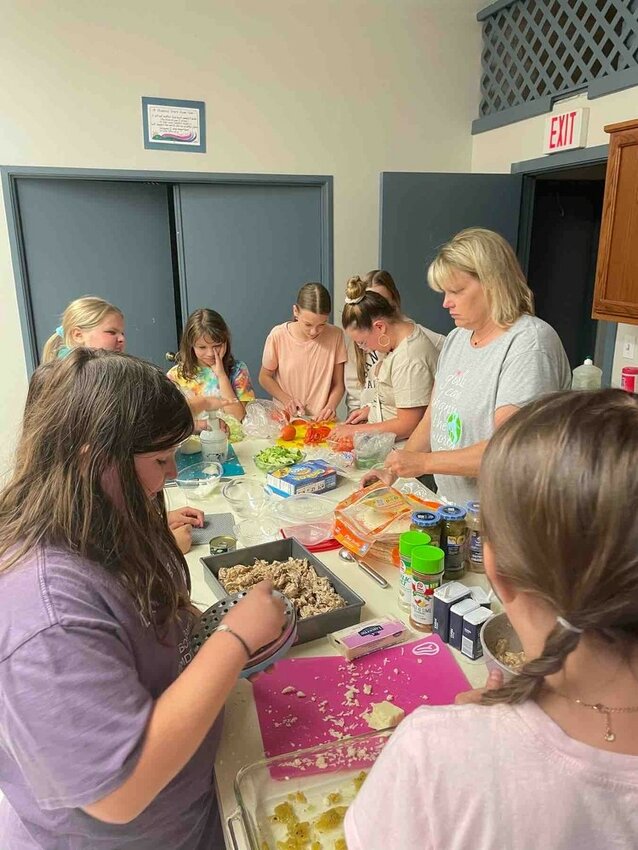 To show appreciation for using the Kiwanis Clubhouse for their meetings, Girl Scout Troop #6445 and their leader Erika Percic prepared dinner for Sunset Kiwanis members.