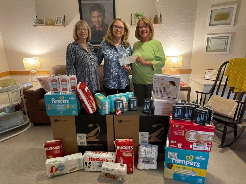 Marking the culmination of the annual charity drive and spring gala, the Ladies in Fellowship Together (LIFT) from Shepherd of the Hills Lutheran Church in Fountain Hills passed along the donated items to founder and directer of Jacob&rsquo;s Hope Jo Jones (center). From diapers, towel warmers and baby carriers, the donated items and financial support will help babies and mothers served at the speciality care nursery in Mesa. Also pictured are Cindy Beck (left) and Donna Hawkinson (right) of Shepherd of the Hills.