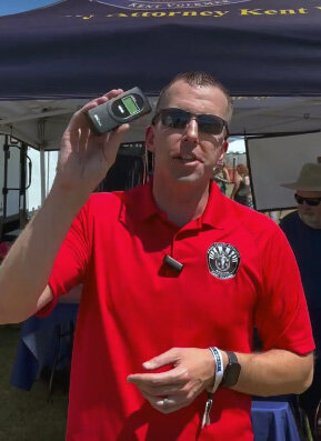 Mike Pelton, public information officer for PCAO, demonstrates promoting sober driving and administering breathalyzer tests for educational purposes at Country Thunder this weekend.
