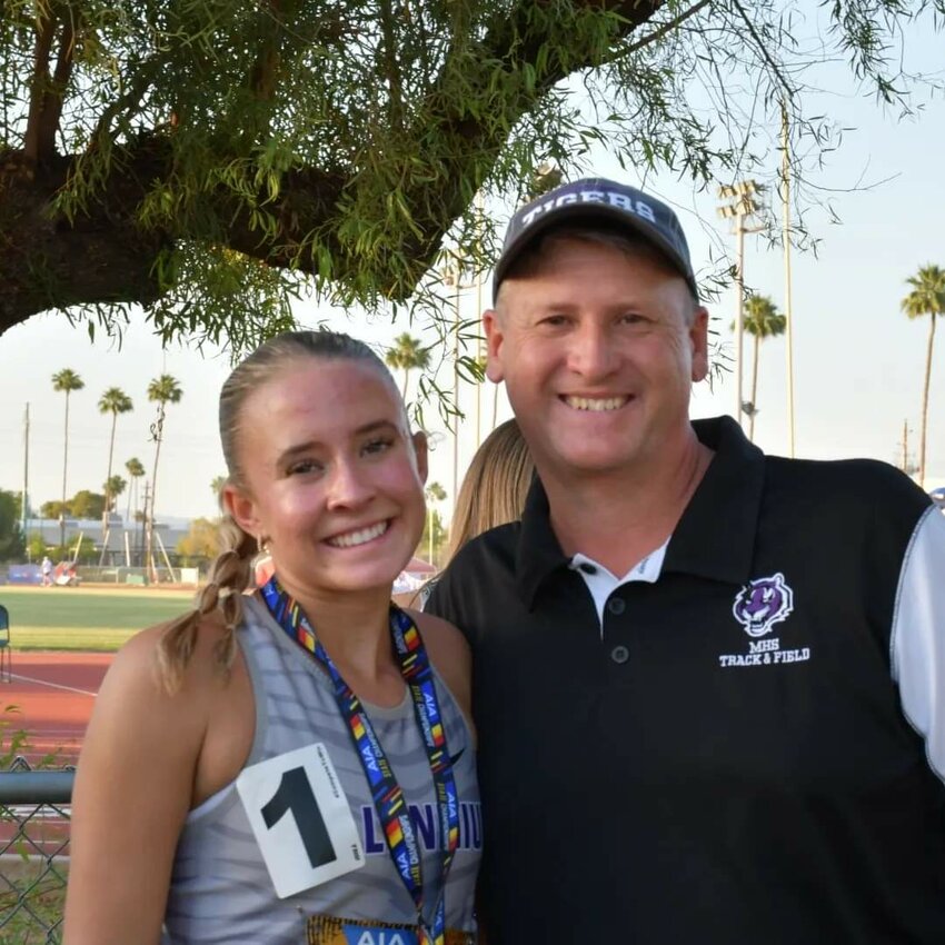 Millennium junior Landen LeBlond and track coach Jim Rafferty smile after LeBlond won the state 1,600-meter race last May in Mesa.