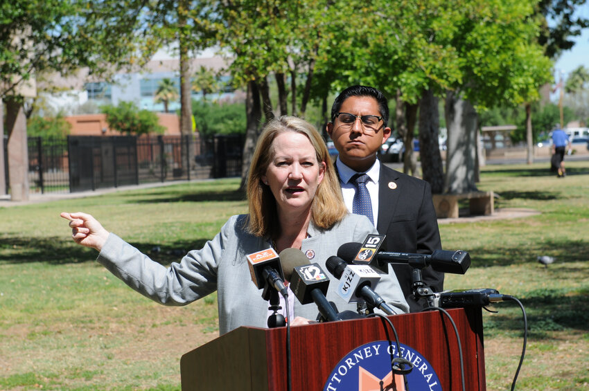 Attorney General Kris Mayes gestures to the state House Thursday as she blasts Republican lawmakers for failing to act on groundwater pumping even as they criticize her for trying to use nuisance laws to rein in the practice. With her is Rep. Oscar De Los Santos, the assistant House minority leader. (Capitol Media Services/Howard Fischer)