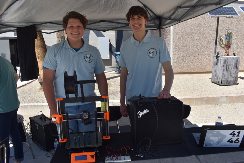 Senior Owen Barker, left, and junior Marco Bartoletti show off a 3-D printer and other musical equipment they use as Melody Makers at the STEAM showcase on Saturday, April 13. (Independent Newsmedia/George Zeliff)