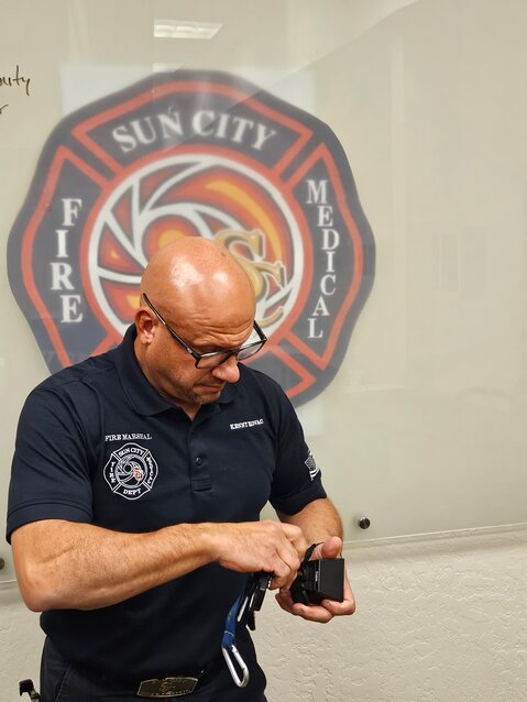 Kenny Kovac, Sun City Fire District fire marshal, demonstrates a lock box.