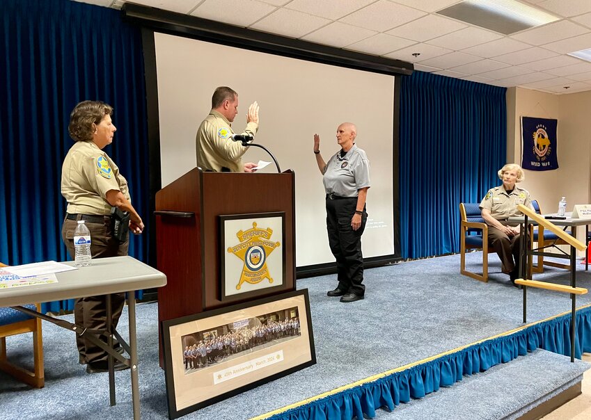 Sun City West Posse Cmdr. Carolyn Patterson and Fran McElroy, Sun City West Posse, watch as Maricopa County Sheriff&rsquo;s Office District Three Capt. Brian Stutsman swears in Joanne Sykes during the April 16 meeting.