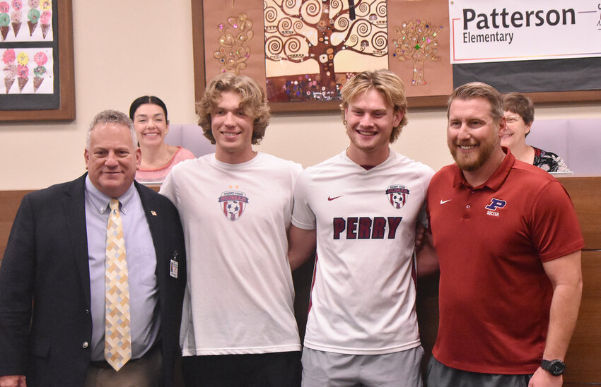 Two senior standouts represented Perry High School&rsquo;s repeat state-champion boys soccer program at a recent Chandler Unified School District Governing Board meeting. From the left are CUSD Superintendent Frank Narducci, Caden Dosmann, Tyler Haren and PHS coach Jason Berg.