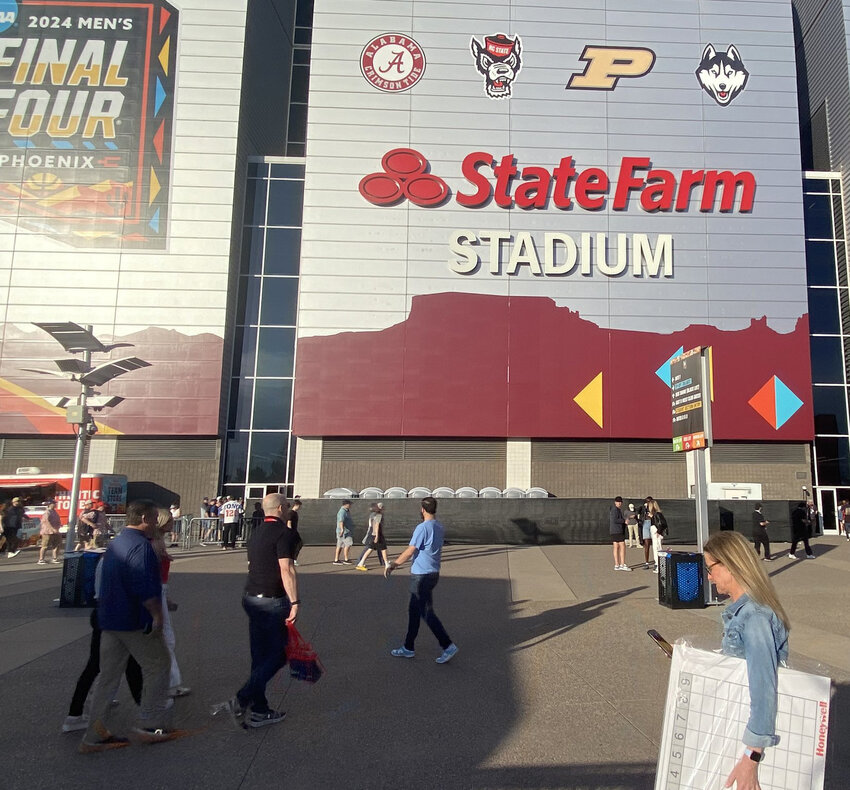 Fans walk around outside State Farm Stadium in Glendale a little more than half an hour before tipoff of the NCAA Men&rsquo;s Basketball championship game between UConn and Purdue April 8.